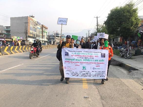 May be an image of 11 people, motorcycle, road and text